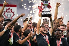 Vancouver Whitecaps' Ryan Raposo hoists the Voyageurs Cup after Vancouver defeated CF Montreal 2-1 during the Canadian Championship soccer final in Vancouver earlier this week.