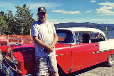 William (Ross) Wheeler of Summerside in the Bay of Islands poses next to his 1955 Chevy Bel Air. Wheeler was injured in a construction accident recently. - Contributed