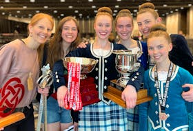 Olivia Burke, third from left, holds her trophies after winning the 16-U18 division at the ScotsDance Canadian Highland Dance Championships on July 5 in Halifax. Surrounding her are her proud teammates and dance teacher from MacArthur School of Dance in Sydney. With Burke are, from left, teaching Kelly MacArthur, Drea Shepherd, Isabelle Pilling, Zoe MacIsaac and Catherine Pilling in the front. CONTRIBUTED