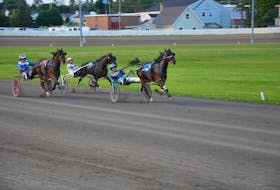 Corey MacPherson drives Mr Rielly, 2, to victory over the Jason Hughes-driven Woodmere Sheldon, left, and Hardy Mill Joe, with Dale Spence in the bike, at Red Shores at Summerside Raceway on July 12. Time of the mile in the $4,200 Horse and Gelding Division, presented by Kays Wholesale, of the P.E.I. Colt Stakes’ Graduate Series was 1:56.4. Jason Simmonds • The Guardian