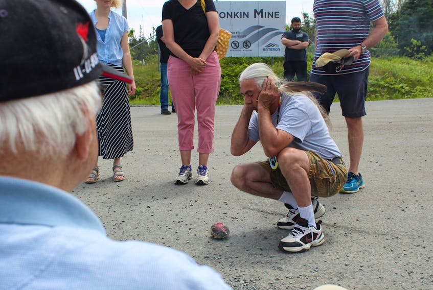 Donald Morrison of Eskasoni First Nation smudges his ears so as to hear no negativity on Saturday at the entrance of Donkin Mine. NICOLE SULLIVAN/CAPE BRETON POST