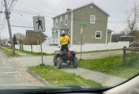 An ATV uses the sidewalk along Lingan Road in Whitney Pier. CONTRIBUTED