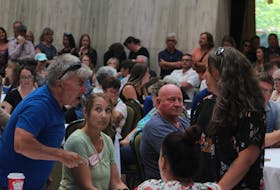 Members of the crowd get into a heated argument during the public information seminar held at the Confederation Centre of the Arts on July 19. Rafe Wright • The Guardian