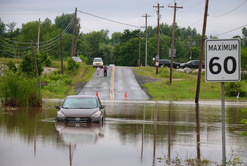 A vehicle was abandoned on Wentworth Road near Windsor due to rising water levels.