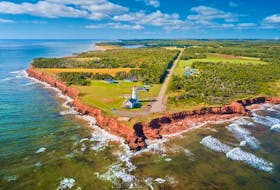 Red sandstone cliffs, rolling green hills and blue ocean awaits visitors along the Points East Coastal Drive in Prince Edward Island. File