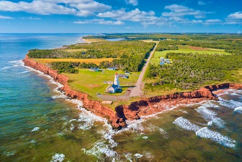 Red sandstone cliffs, rolling green hills and blue ocean awaits visitors along the Points East Coastal Drive in Prince Edward Island. File