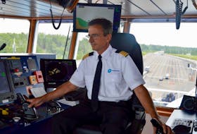 Capt. Eric Boucher steers the MV Saaremaa away from the dock at Caribou, N.S., and into the narrow channel in the Northumberland Strait.