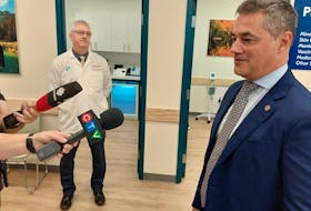 Jeff Léger, the president of Shoppers Drug Mart, tells reporters his company has a national strategy of rolling out more clinics that can help patients with chronic conditions. Brian Barry, the owner of the Shoppers in uptown Fredericton, listens.