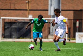 York United's Kevin Santos, left, tries to fend off HFX Wanderers' Mohamed Omar during Canadian Premier League action on Sunday in Toronto. - Canadian Premier League