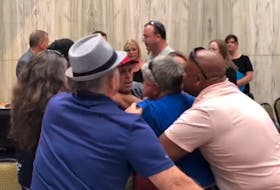 This screenshot from a Tweet by Guardian reporter Rafe Wright shows people struggling with a man who had, moments before, shoved Housing Minister Rob Lantz, during a July 19, 2023 public meeting in Charlottetown over the location of a proposed overdose prevention site.