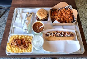 Big D's Poutine Eighth Wonder of the World eating challenge includes a triple-stacked burger, a large specialty poutine, a foot-long hot dog, a quarter-pound donair, brisket mac and cheese, a milkshake and a custom side dish. Facebook photo