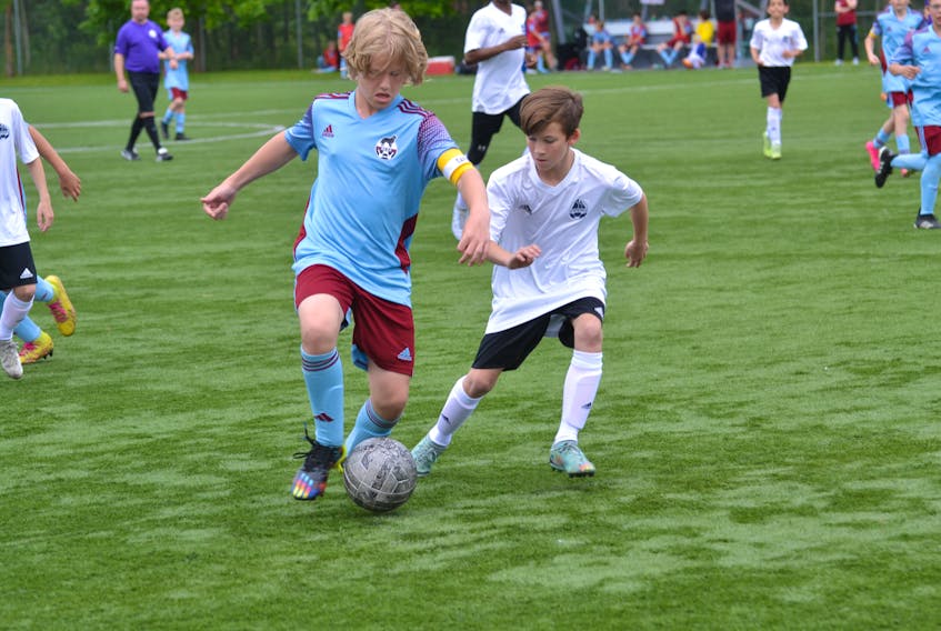 Players from Newfoundland and Labrador and Nova Scotia battle for control of the ball in day two of play at the U13 Boys Atlantic Championships at the Doug Sweetapple Soccer Field in Corner Brook on Friday, July 7. - Diane Crocker/SaltWire