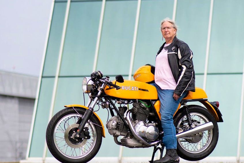 A 2020 photo of Geena Green posing with her beloved 1974 Ducati 750 Sport motorcycle, the first bike she ever owned.