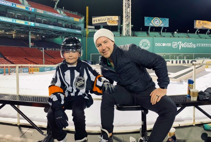 Carter McIsaac (left) with his father, NHL referee Jon McIsaac, at the stadium. Carter is dressed for his father's job. Contributed
