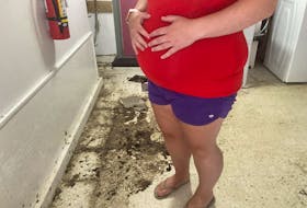 A pregnant woman living at the Brule Street apartment building says she's concerned that the property is falling into disrepair.  She's shown in the laundry room on Tuesday where a mess was left behind from flooding from a record rainstorm last month. The landlord had workers clean it up later that day.