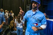 Jose Bautista gestures after addressing the media during a news conference at the Rogers Centre in Toronto on Friday Aug. 11, 2023. Bautista signed a one-day contract to officially retire as a member of the Toronto Blue Jays. 