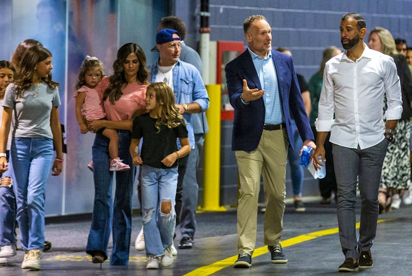  Jose Bautista, right, arrives with his family and Toronto Blue Jays president and CEO Mark Shapiro for a news conference at the Rogers Centre in Toronto on Friday, Aug. 11, 2023. Bautista signed a one-day contract to officially retire as a member of the Toronto Blue Jays.