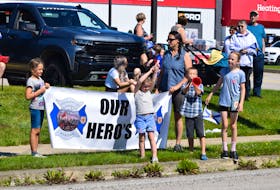 Signs and banners thanking and honoring the emergency responders and others who helped battle the Barrington Lake wildfire dotted the parade route in Barrington Passage on Aug. 12 for the emergency services appreciation parade. KATHY JOHNSON