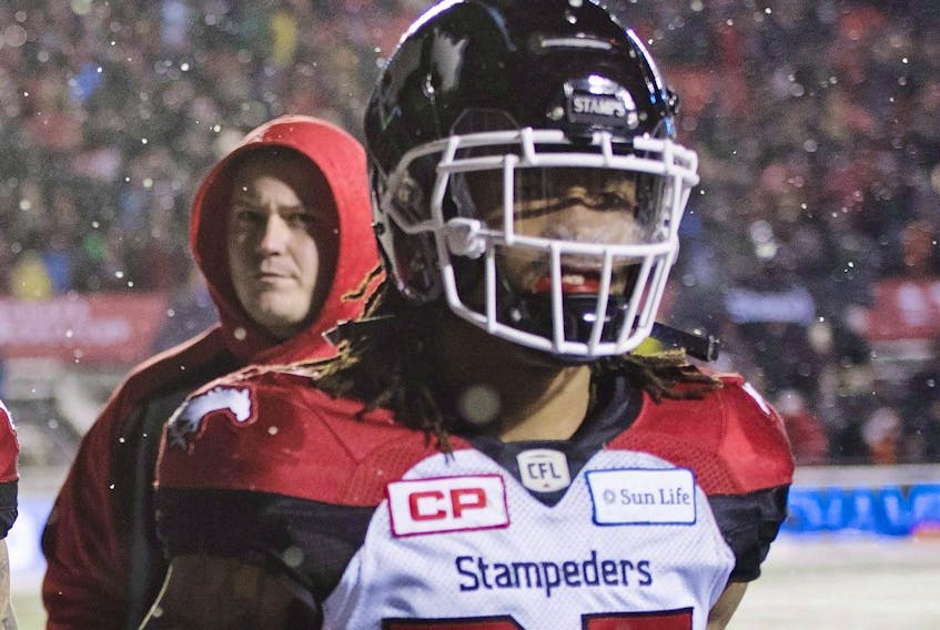 Calgary Stampeders' Shaquille Richardson walk off the field after being defeated by the Toronto Argonauts in the 105th Grey Cup.
