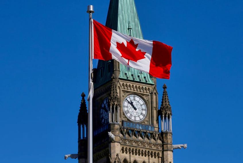 Canadian flag flies in front of the Peace Tower on Parliament Hill in Ottawa.