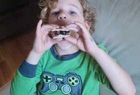 Janice Wells’ grandson Miles with a grapes, butter and cracker sandwich, his own creation. Janice Wells photo