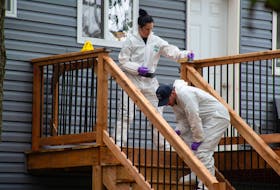 Forensic identification officers look for evidence at the scene of a homicide on Twin Oaks Road in Halifax on Wednesday, Aug. 16, 2023. Police arrested a 36-year-old man at the scene.