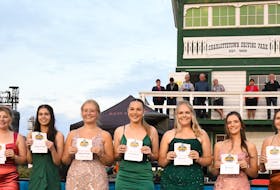 The Gold Cup and Saucer ambassadors hold the cards displaying the horses they will represent in the Aug. 19 final, which goes for a purse of $100,000 at Red Shores Racetrack and Casino at the Charlottetown Driving Park. The official draw for post positions took place during the Aug. 15 Old Home Week harness racing program. The ambassadors, with their horse and post position in parenthesis, are, from left: Alyssa Cooper, Roll Em (Post 7); Lacey White, Twin B Tuffenuff (Post 4); Cassie Stewart, Lawless Shadow (Post 2); Gracie Clark, American History (Post 3); Lily Hickey, Covered Bridge (Post 9); Gillian Fraser, Major Hill (Post 8); Taylor MacBeath, Bee Two Bee (Post 6); Emma Richard, P L Ozzy (Post 1), and Shaelyn Crane-Paterson, Funatthebeach N (Post 5). Gail MacDonald Photo • Special to The Guardian