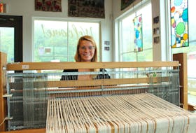 Melissa Tarrant using a loom, a device used to weave fabrics together. She encourages anyone to come Quidi Vidi Studio's, between Friday and Monday to try out their community weaving. Cameron Kilfoy/The Telegram.
