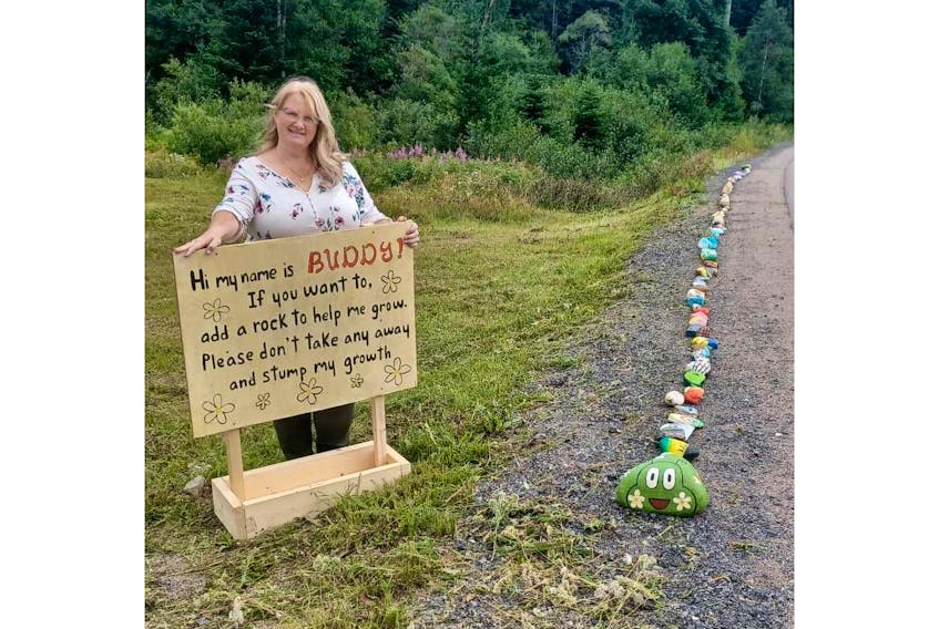 Jenny Gale, the municipal clerk in Pollard's Point, put up a sign next to Buddy the rock caterpillar that asks people not to take any of the rocks that make up Buddy's body. - Contributed