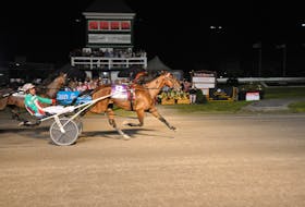 Jordan Stratton drives Covered Bridge, 9, to victory in the he 64th edition of The Atlantic Lottery Gold Cup and Saucer in the early minutes of Aug. 20 at Red Shores at the Charlottetown Driving Park. Time of the mile in the $100,000 race was 1:50.3. Gail MacDonald Photo • Special to The Guardian