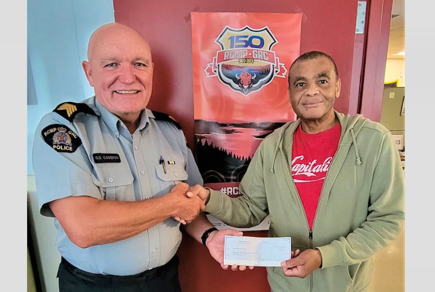 Digby RCMP S/Sgt. George Cameron presents Kerry Johnson, president of the Jordantown Acaciaville Conway Betterment Association (JACBA) with a cheque for the RCMP’s donation towards the new community centre. CONTRIBUTED