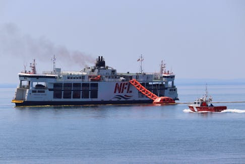 A Canadian Coast Guard boat heads out to the MV Holiday Island, a Northumberland Ferries Limited vessel that caught fire on July 22, 2022 and continued to burn on July 23. – SaltWire file