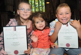 Shea Heights cousins Aubree Grouchy, 8, left, and Patrick Keough, 6, right, helped save three-year-old Leah Keough, centre, from drowning in the family swimming pool on July 19, 2022. They were presented with a silver life-saving award from the Newfoundland and Labrador St. John Ambulance for their efforts.
—Photo by Joe Gibbons/SaltWire