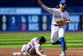 Blue Jays' hitter Bo Bichette gets the force out on Cleveland Guardians' Myles Straw while trying to turn a double play during the third inning in Toronto, Sunday, Aug. 27, 2023. 