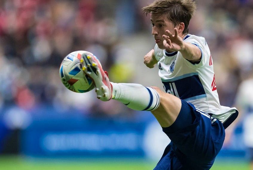 Vancouver Whitecaps' Ryan Gauld scored twice against the Portland Timbers Saturday Aug. 26, 2023. In this file photo, he knocks the ball out of the air with his foot against the Seattle Sounders in 2021.