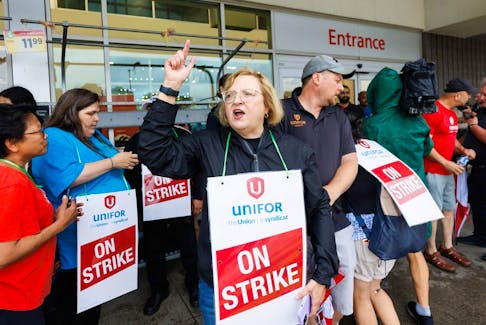 Lana Payne, the Unifor National president, shouts alongside workers at a picket line outside a Metro grocery store in Toronto on July 29.