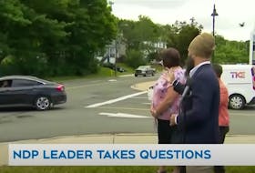 In this image from CTV News, the driver of the black car (at left) yells expletives at NDP Leader Jagmeet Singh during his visit to St. John’s, Aug. 1. Screengrab