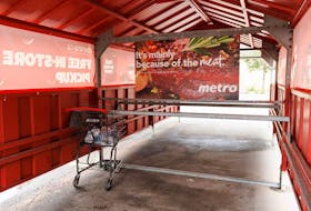 A lone shopping cart is seen outside a Metro grocery store in Toronto after workers went on strike in July.