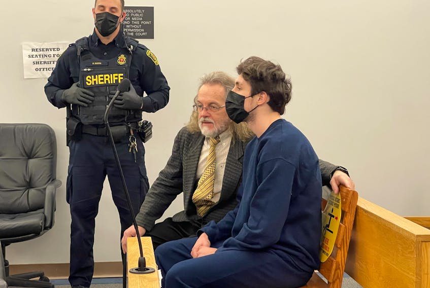 Tyler Greening, 18, sits next to his lawyer, Bob Buckingham, in provincial court in St. John's on March 17. TELEGRAM FILE PHOTO