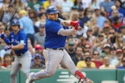 Alejandro Kirk of the Toronto Blue Jays connects on an RBI double against the Boston Red Sox during the third inning at Fenway Park on August 5, 2023 in Boston, Massachusetts.