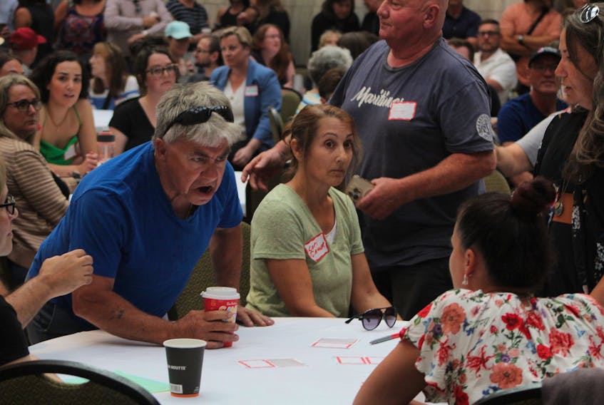 An angry audience member screams vulgarities at a fellow audience member during a public information seminar held on July 19 regarding the opening of a new overdose prevention site on Park Street. - Rafe Wright/SaltWire