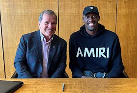 UNB president and vice-chancellor Paul Mazerolle, left, sits with NBA all-star forward Pascal Siakam who have partnered to establish a new student scholarship for student heading to UNB from Cameroon. Contributed