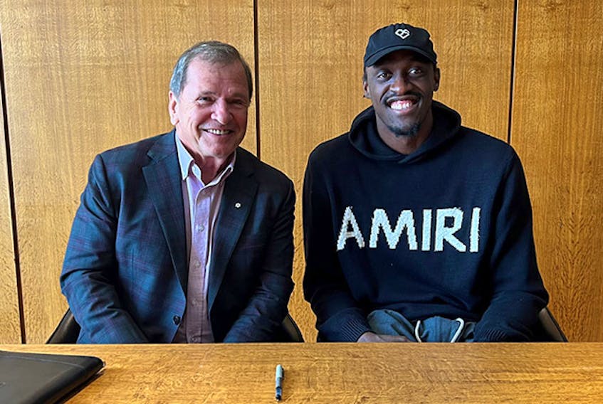 UNB president and vice-chancellor Paul Mazerolle, left, sits with NBA all-star forward Pascal Siakam who have partnered to establish a new student scholarship for student heading to UNB from Cameroon. Contributed