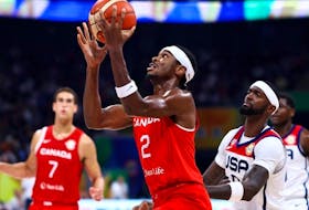 Shai Gilgeous-Alexander #2 of Canada drives to the basket against Bobby Portis #9 of the United States in the second quarter during the FIBA Basketball World Cup 3rd Place game at Mall of Asia Arena on September 10, 2023 in Manila, Philippines.