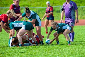 The UPEI Panthers’ Mia Fradsham picks up the ball and checks her options for making a pass in an Atlantic University Sport (AUS) Women’s Rugby Conference game against the Acadia Axewomen on Sept. 9. The Panthers won the season-opening contest 27-15 before a big crowd at MacAdam Field on the UPEI campus in Charlottetown. Janessa Vanden Broek/UPEI Athletics • Special to The Guardian