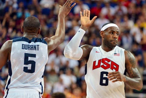 U.S. forward Kevin Durant (L) and U.S. forward LeBron James (R) high-five during the London 2012 Olympic Games men's gold medal basketball game between USA and Spain.