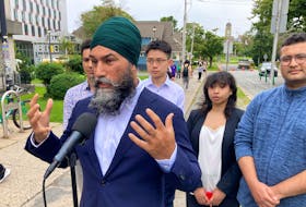 Federal NDP Leader Jagmeet Singh, accompanied by Dalhousie University graduate students, speaks to media in front of the Dalhousie student union building on University Avenue in Halifax on Monday, Sept. 11, 2023.