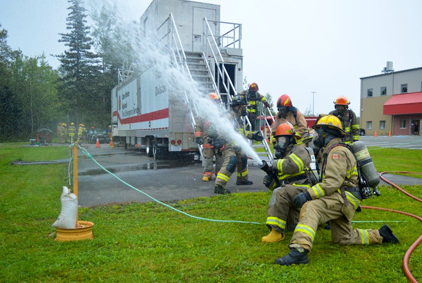 Cape Breton Regional Municipality Mayor Amanda McDougall uses a fire hose during Fire Ops 101 in Sydney on Monday. The event hosted by the International Association of Fire Fighters Local 2779 allows people to experience  what a day in the life of a firefighter is like. Photo by Al MacQueen