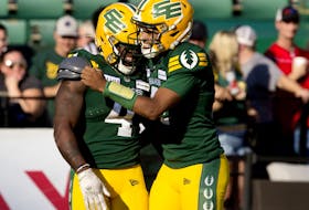 Edmonton Elks running back Kevin Brown (4) and quarterback Tre Ford (2) celebrate a touchdown against the Calgary Stampeders at Commonwealth Stadium in Edmonton on Saturday, Sept. 9, 2023.