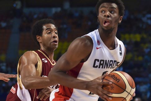 Venezuela's point guard Gregory Vargas (L) and teammate John Cox (C) mark Canada's shooting guard Andrew Wiggins (R) during their 2015 FIBA Americas Championship.